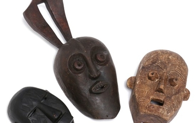 Three masks of carved patinated wood, one with traces of white kaolin. Makonde and D. R. Congo style. H. 27–62 cm. (3)