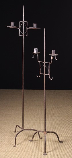 Two Similar Wrought Iron Floor Standard twin-socket Candle Holders; one 18th century, the other late