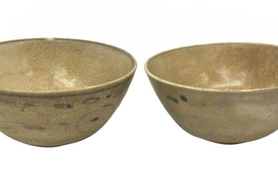 Two glazed ceramic celadon bowls with simple