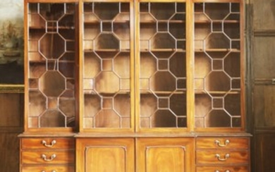 A reproduction mahogany breakfront bookcase