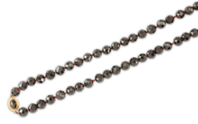 A garnet bead necklace The series of faceted...