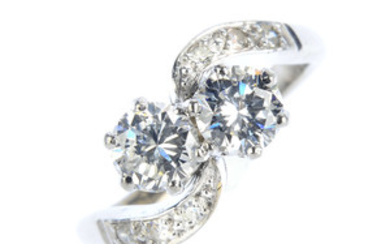 A mid 20th century 18ct gold and platinum diamond two-stone crossover ring. View more details