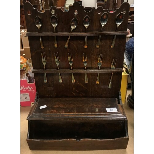 A 19th Century provincial oak spoon rack of two tiers with b...