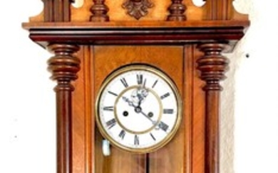 A 19th century walnut wall mounted clock with white enemal dial. H. 132 cm.