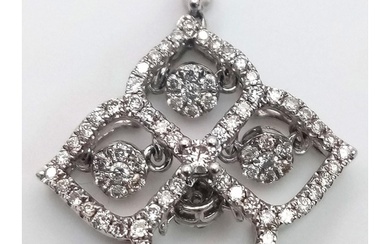 A 9 K white gold four sector pendant with diamonds and movin...
