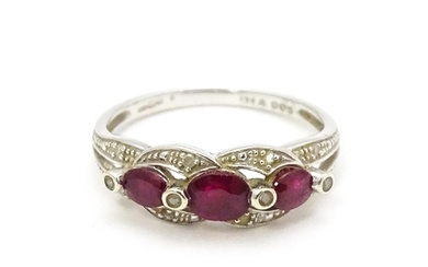 A 9ct white gold ring set with rubies and diamond. Ring siz...