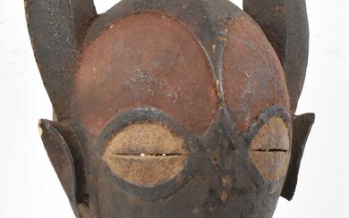 A Baule, Ivory Coast, horned masked with traces of pigmentation,...