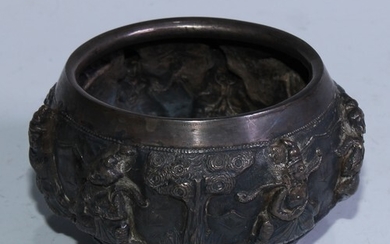 A Burmese silver bowl, repousse chased with figures and palm...