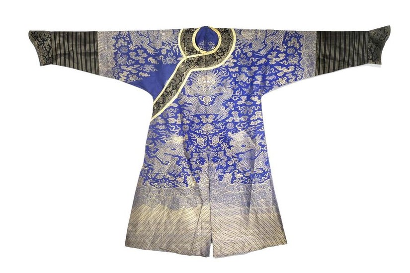 A CHINESE BLUE-GROUND EMBROIDERED SILK 'DRAGON' ROBE LATE...