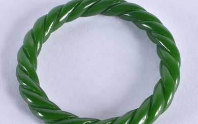 A CHINESE CARVED SPIRAL JADE BANGLE 20th Century. 38.4 grams. 6 cm diameter.