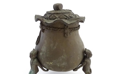 A Chinese cast bronze pot and cover modelled as a money bag ...
