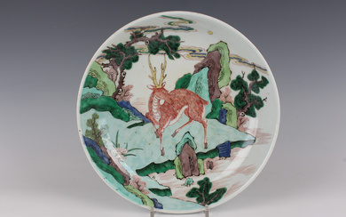 A Chinese famille verte porcelain saucer dish, Kangxi style but later, painted with a deer standing