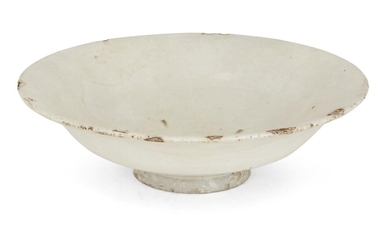 A Chinese stoneware Cizhou-type white-glazed bowl, Northern Song dynasty, on short foot with curving sides that rise to an everted rim, covered in white slip under a clear glaze, 18.5cm diameter