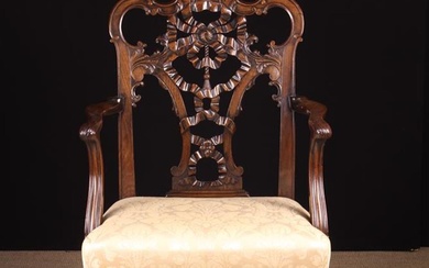 A Chippendale Style Carved Mahogany 'Ribbon-back' Armchair. The pierced back centre with foliate cre