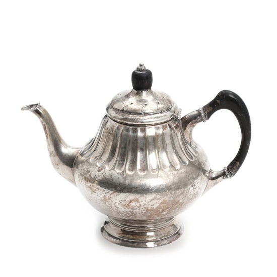 A Danish silver teapot with black painted wood handle and finial. Grann...