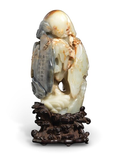 A GREENISH-WHITE AND GREY JADE 'LUOHAN AND GROTTO' GROUP