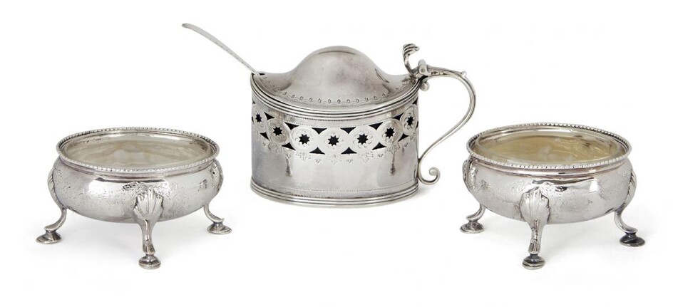 A George III blue glass-lined silver mustard, London, c.1804, Peter, Ann & William Bateman, together with a pair of cauldron-shaped salts by Hester Bateman, London, c.1821, the mustard designed with star pierced sides and domed hinged lid with...