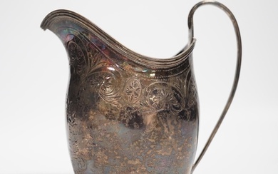 A George III engraved silver helmet shaped cream jug, London...