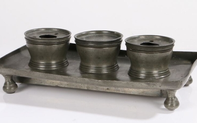 A George III pewter standish, circa 1790, the flat rounded-rectangular tray with shallow rim, raised