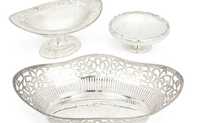 A George V silver dish with foliate pierced border, Birmingham, 1910, S. Glass, raised on a stepped oval foot, 24.3cm long, 11.8cm high, together with a smaller silver footed circular dish with crimped rim, Birmingham, 1965, Barker Ellis Silver...