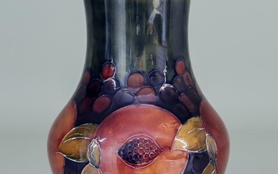 A Moorcroft Vase, tubelined with "Pomegranate" design, on a...