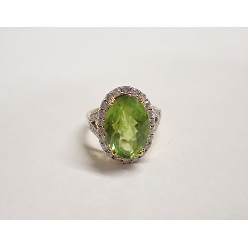 A Peridot and Diamond Cluster Ring claw-set faceted oval per...