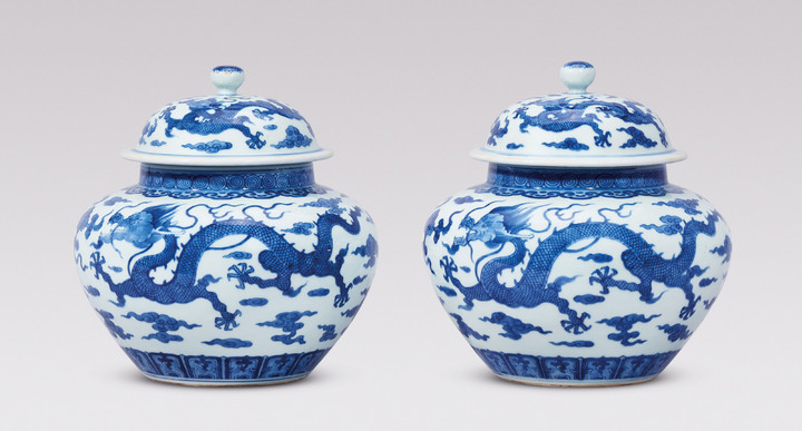 A RARE PAIR OF BLUE AND WHITE ‘DRAGON’ JARS AND COVERS, QING DYNASTY, 18TH CENTURY