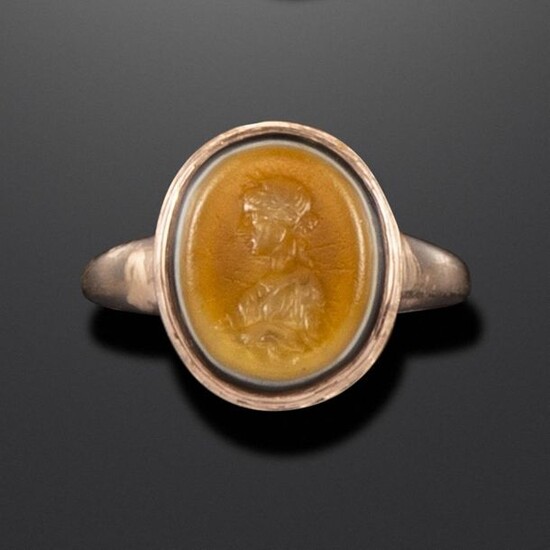 A Roman sardonyx intaglio depicting Salus, c1st century BC - 1st century AD, the bust depicted in profile with a snake below, in a later gold ring mount, with maker~s mark SP, intaglio 1.3cm high, ring size R 1/2 Salus was the ancient Roman goddess of...