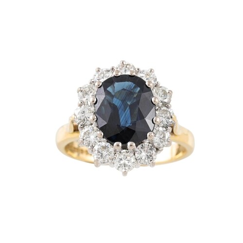 A SAPPHIRE AND DIAMOND CLUSTER RING, with oval shaped sapphi...