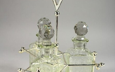 A THREE BOTTLE TANTALUS, in a plated frame.
