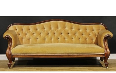 A Victorian mahogany sofa, serpentine cresting rail, stuffed...
