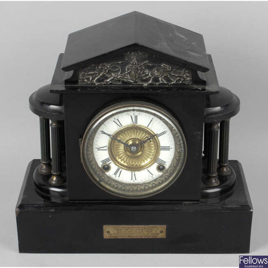 A Victorian painted metal faux black slate mantel clock.