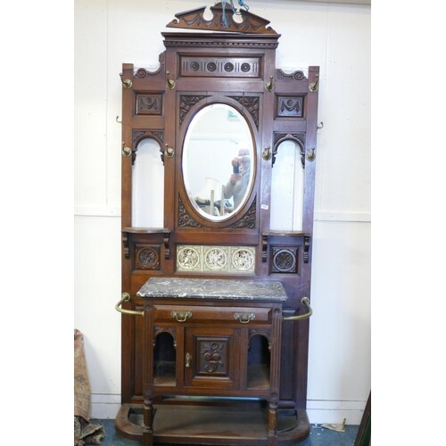 A Victorian walnut hall stand, with broken pediment top over...