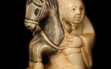 A WOMAN HOLDING A HORSE HEAD SCULPTURE