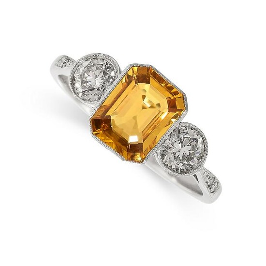 A YELLOW SAPPHIRE AND DIAMOND RING set with an emerald