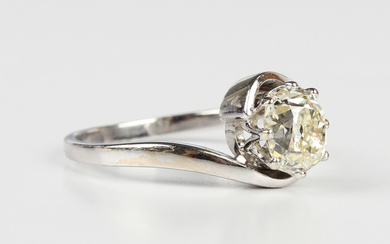 A diamond single stone ring, claw set with a cushion cut diamond in a twistover design, weight 2.9g