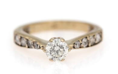 SOLD. A diamond solitaire ring set with a diamond weighing app. 0.70 ct. flanked by...
