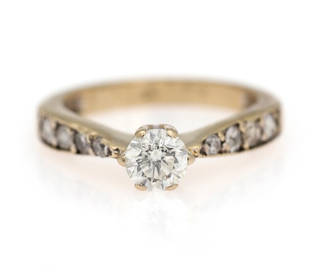 SOLD. A diamond solitaire ring set with a diamond weighing app. 0.70 ct. flanked by...