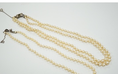 A double strand graduated cultured pearl necklace, with a wh...