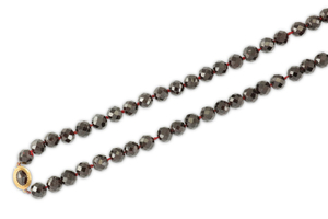 A garnet bead necklace The series of faceted...