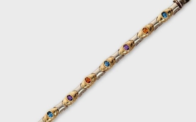 A gem-set fourteen karat bi-color gold strap bracelet
