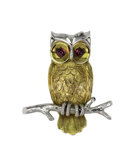 A gold and ruby brooch, designed as an Owl, with textured feathers and cabochon ruby eyes, perched on a branch, British hallmarks for 18-carat gold.