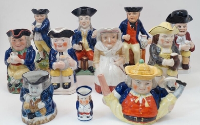 A group of Staffordshire Toby jugs, 19th century and later, to include a gentleman in blue jacket with a pipe and mug of ale, 'Hearty Good Fellow', 28.5cm high; a sailor in a blue jacket seated on a chest and holding a mug and jug, 29cm high; a...