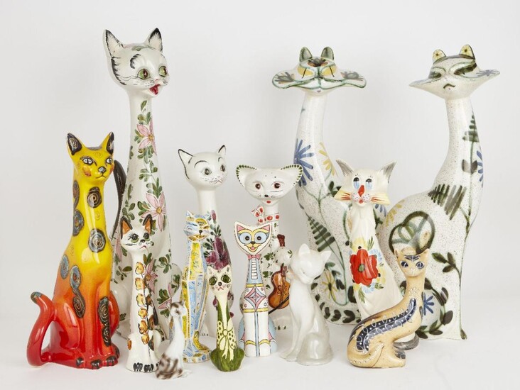 A group of pottery cats with elongated necks and pronounced whiskers, of varying size and design, to include a pair of Cinque Port Pottery cats with floral decoration, factory stamp to base, 53cm high, and others, tallest 56.5cm (lot)