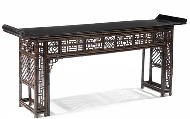A large Chinese bamboo and black-lacquer console table. Last half of the...