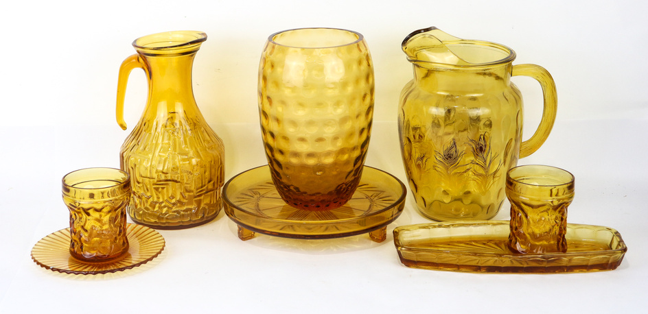 A large lot of vintage amber glass including plates, dishes,...