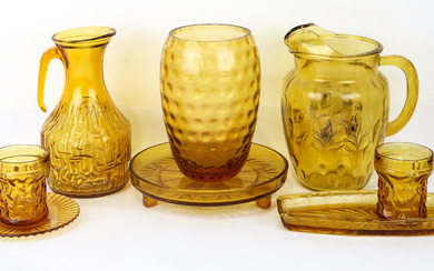 A large lot of vintage amber glass including plates, dishes,...
