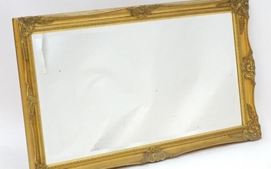 A late 20thC gilt mirror with a moulded frame. 54" wide