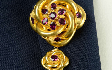 A late Victorian gold foil back purple garnet foliate stylised knot brooch.