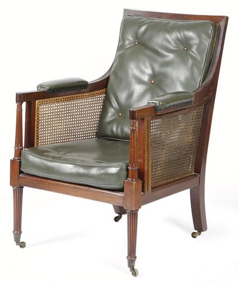 A mahogany bergère armchair in Regency style, with…